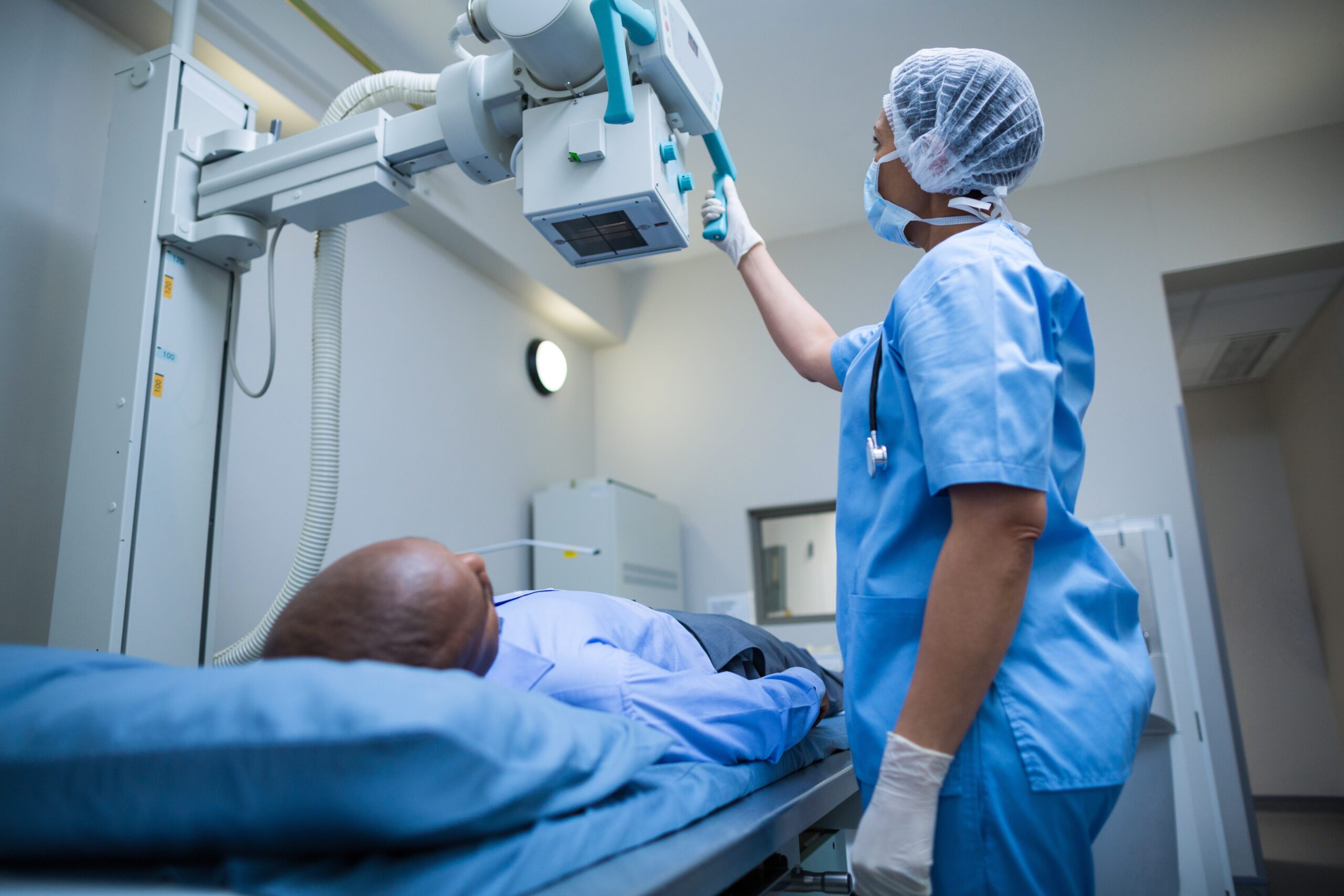 Inductors and coils are used in medical equipment. Doctor sets up the machine to x-ray over patient